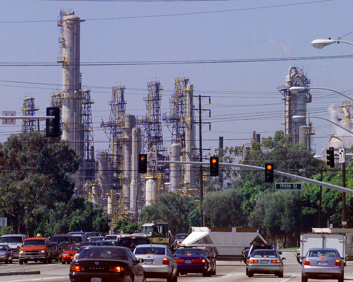 The Mobil oil refinery is seen behind the intersection of 190th Street and Crenshaw Blvd., Friday, July 30, 1999 in Torrance, Calif. An explosion forced Mobil Corp. to cut production at its Torrance refinery on Wednesday, resulting in an influence on rising prices. Nationally, the average price of gasoline at the pump has risen more than 5 cents to 126.7 cents per gallon since early July. Since February, gasoline has risen 26.9 cents per gallon nationwide. (AP Photo/Nick Ut)
