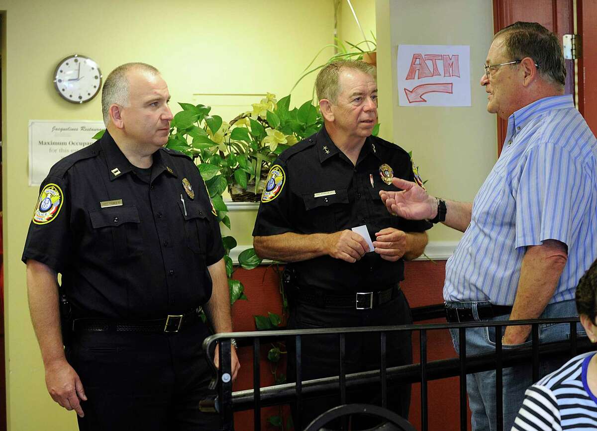 Bethel Police Captian Stephen Pugner, left, Chief Jeffrey Finch, chat with town resident Lawrence Bocchiere III at Jacqueline's Restaurant on Wednesday morning, August 10, 2016. Bocchiere was interested in traffic issues and handicapped parking. The Bethel police held what they called a "Coffee with a Cop" event to allow members of the community to get to know them.