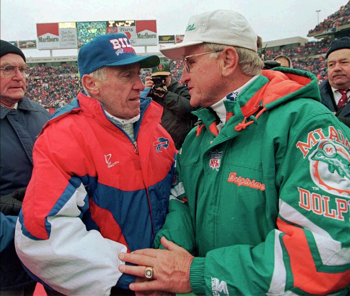FILE - In this Dec. 30, 1995, file photo, Buffalo Bills head coach Marv Levy, left and Miami Dolphins head coach Don Shula speak at midfield after the Bills beat the Dolphins in Shula's final game as head coach, at Rich Stadium in Orchard Park, N.Y. Shula, who won the most games of any NFL coach and led the Miami Dolphins to the only perfect season in league history, died Monday, May 4, 2020, at his home in Indian Creek, Fla., the team said. He was 90.(AP Photo/Bill Sikes, File)