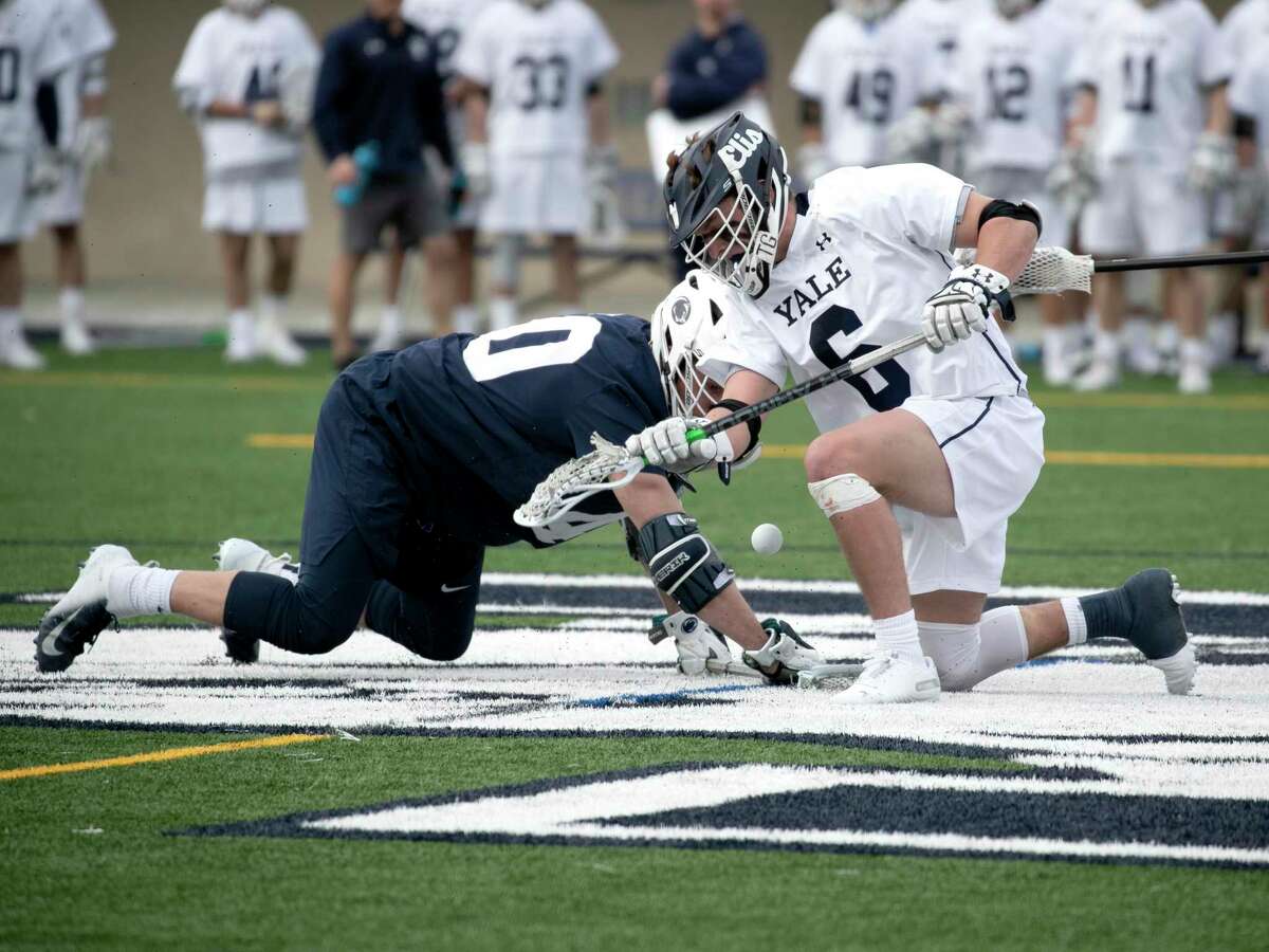 Yale's TD Ierlan in a face-off battle with Penn State's John Nostrant.