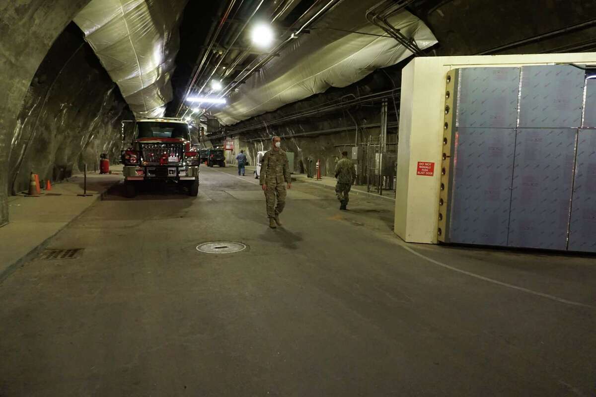 U.S. military personnel work at Cheyenne Mountain, a Cold War-era facility built into a Colorado mountain, where a team of about 130 service members cloistered from their families and the broader military community are now operating an air defense and watch mission for North American Aerospace Defense Command (NORAD).