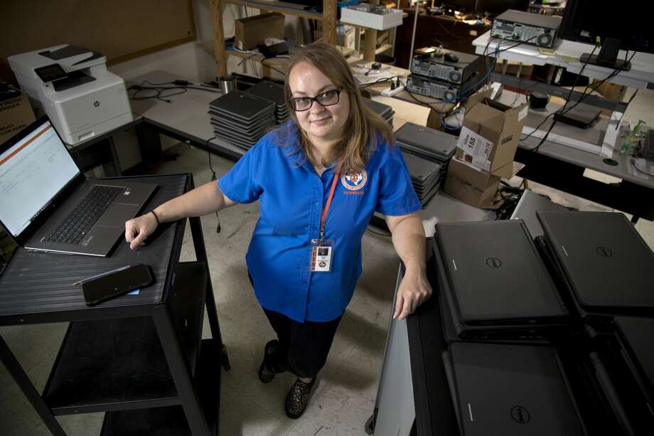 Kacey Hill, a technology technician at Texas City High School in Texas City ISD, has worked during the shutdown to support all 1,800 students who receive a laptop from the campus, as well as families with children attending other schools in the district. Photo: Brett Coomer/Staff Photographer / © 2020 Houston Chronicle
