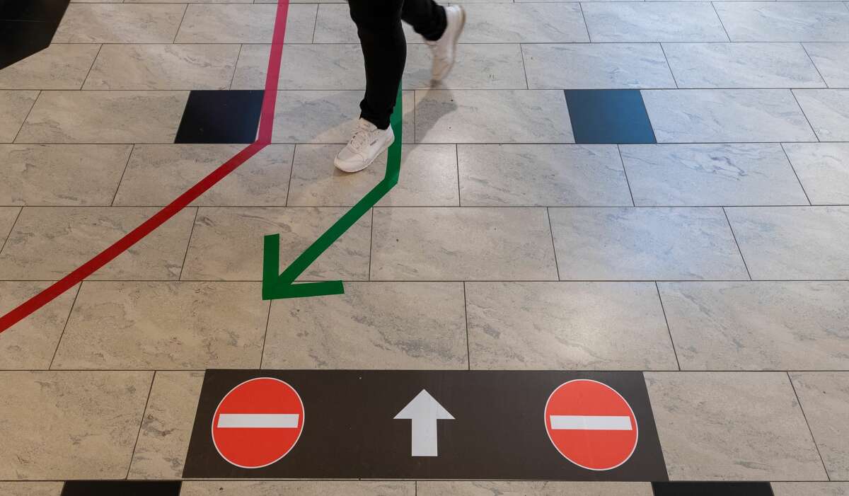 The arrows aim to direct traffic, keeping people moving in one direction to prevent inadvertent contact in walkways.