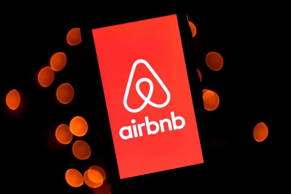 (FILES) This file illustration taken on November 22, 2019, shows the logo of the online lodging service Airbnb displayed on a smartphone in Paris. - Airbnb said on March 26, 2020, it would provide free or subsidized housing for up to 100,000 relief workers responding to the coronavirus pandemic around the world. (Photo by Lionel BONAVENTURE / AFP) (Photo by LIONEL BONAVENTURE/AFP via Getty Images)