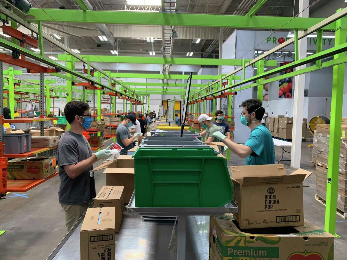 Volunteers pack boxes at the Houston Food Bank.