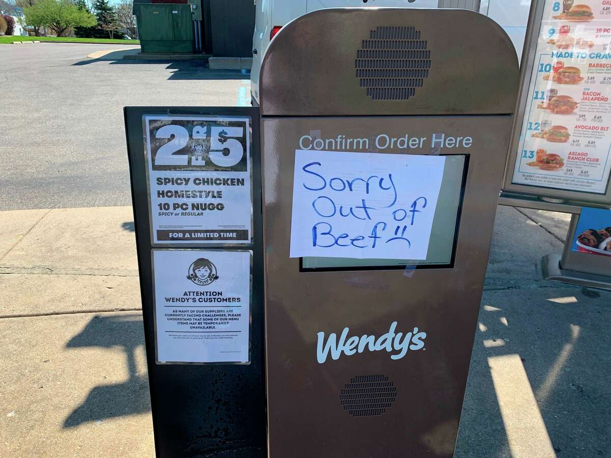 Wendy's manager Pat Milligan posts a sign on the Wendy's drive through letting customers know they are out of beef. Issues with factory suppliers shutting down has caused shortages of beef products. (Pioneer photo/Cathie Crew)