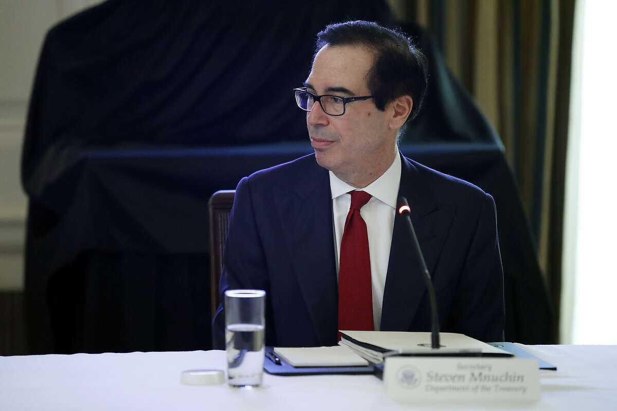 Treasury Secretary Steven Mnuchin listens during a roundtable with industry executives, in the State Dinning Room of the White House, Wednesday, April 29, 2020, in Washington. (AP Photo/Alex Brandon)