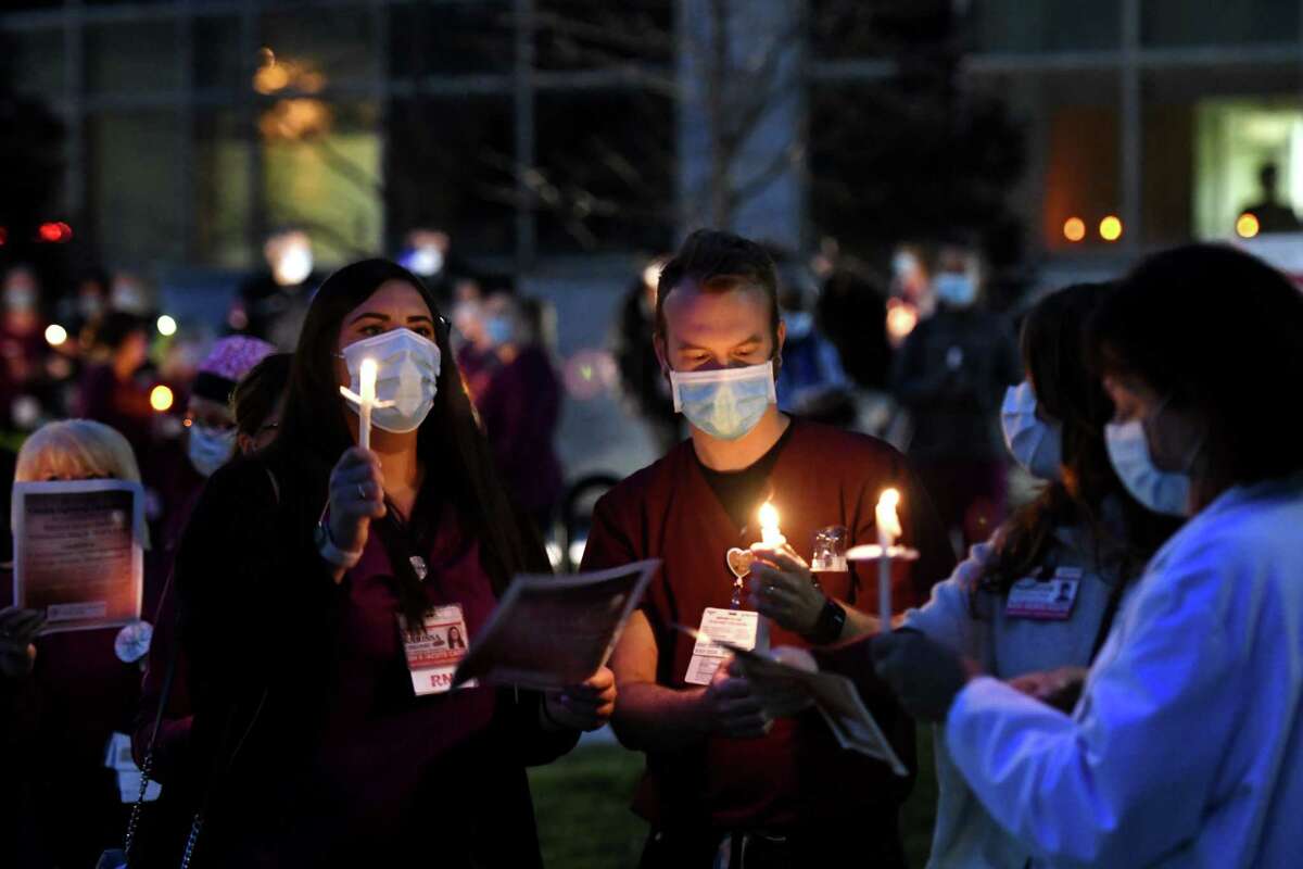 Nurses and staff from St. Peter's Health Partners line South Manning Boulevard outside St. Peter's Hospital where they held a candle lighting ceremony in celebration of National Nurses Month on Wednesday night, May, 6, 2020, in Albany, N.Y. A similar event was held at Samaritan Hospital in Troy. Organizers hope that the ceremony shows that healthcare workers can serve as a guiding light through the COVID-19 pandemic. (Will Waldron/Times Union)