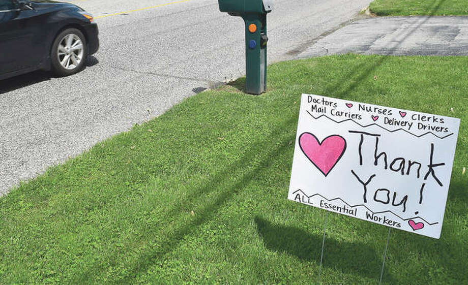 A front-porch sign thanking essential workers is displayed in front of Max Nelson’s house. Photo: Marco Cartolano | Journal-Courier