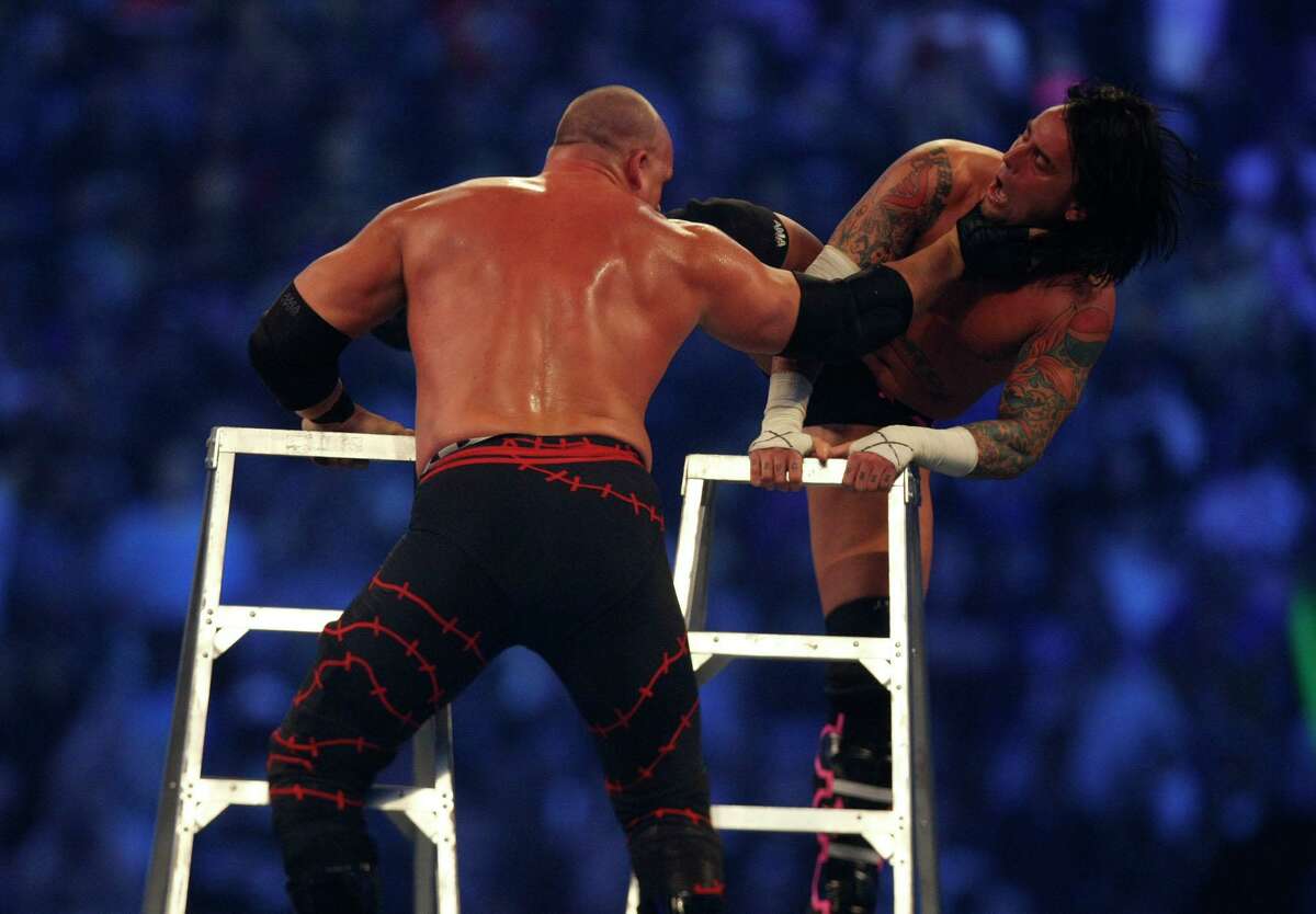 WWE wrestler CM Punk, right, tries to knock down his final opponent, Kane, during the Money in the Bank Ladder Match during the 25th anniversary of Wrestlemania held at Reliant Stadium on Sunday, April 5, 2009, in Houston. For the 2020 Money in the Bank, WWE shot the ladder matches at its headquarters in Stamford, Conn.