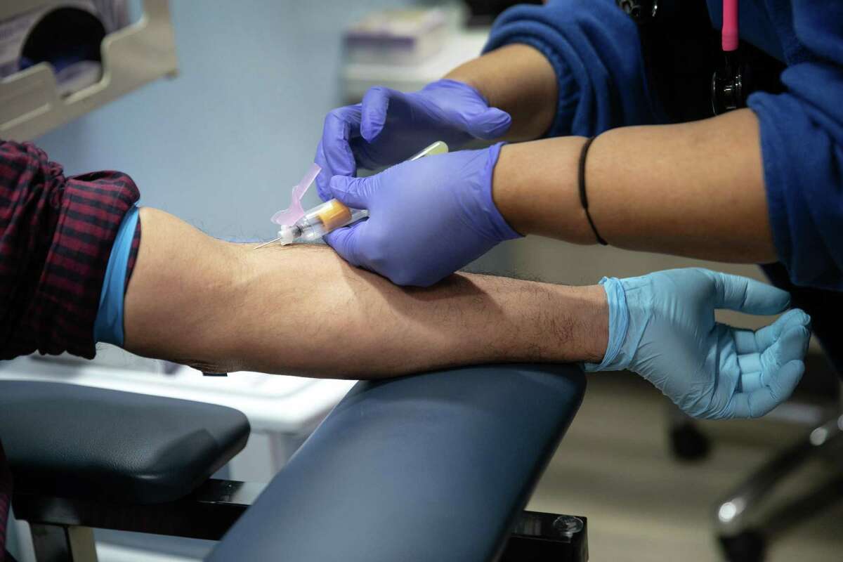 A nurse draws blood for a COVID-19 antibody test at a clinic on May 5, in Stamford, Connecticut. (Photo by John Moore/Getty Images)