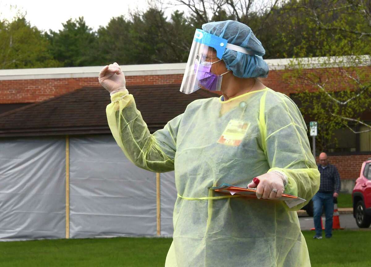 A healthcare worker directs a driver at a COVID-19 testing site behind Warren County Municipal Center on Thursday, May 7, 2020 in Queensbury, N.Y. (Lori Van Buren/Times Union)