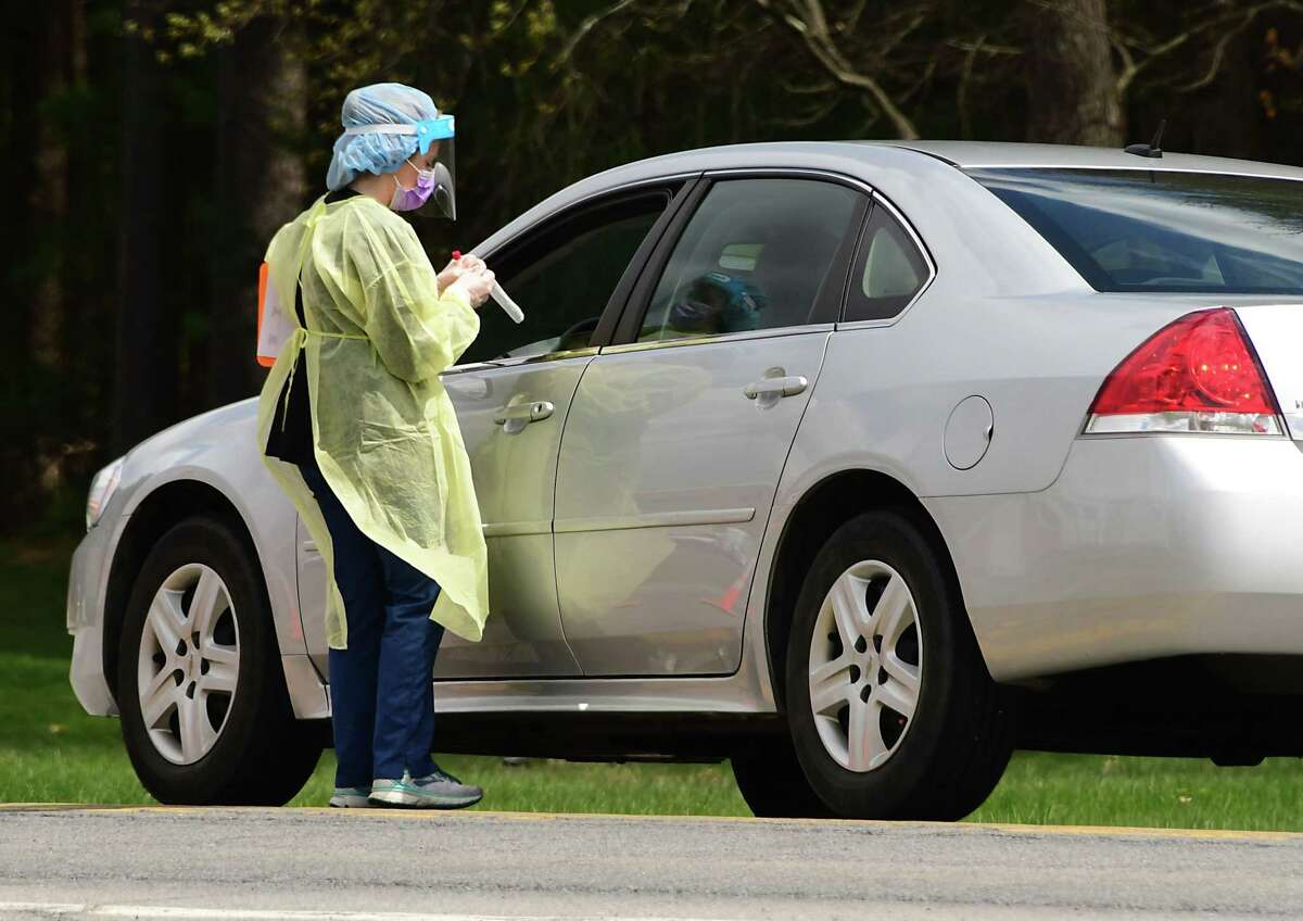 A healthcare worker gets ready to test a patient at a COVID-19 testing site behind Warren County Municipal Center on Thursday, May 7, 2020 in Queensbury, N.Y. (Lori Van Buren/Times Union)