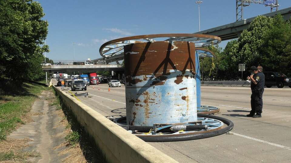 Houston police and wreckers remove loose spools from the Katy Freeway at Houston Avenue on Thursday, May 7, 2020.