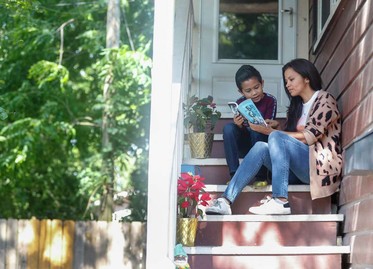 Frida Villalobos, the communication director for Harris County Commissioner Adrian Garca is also a single mom to a 7-year-old Gael, sits on their front steps in Houston, Wednesday, May 6, 2020.