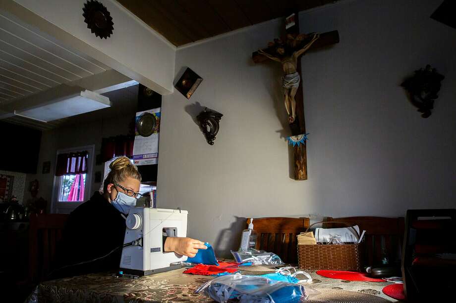 Gloria Buenrostro on her sewing machine makes a mask at her home on Saturday, May 2, 2020, in Half Moon Bay, Calif. Volunteers at Ayudando Latinos A So–ar (ALAS) are making and providing masks for free to farm workers, housecleaners and other essential workers amid the coronavirus pandemic. Photo: Photos By Santiago Mejia / The Chronicle