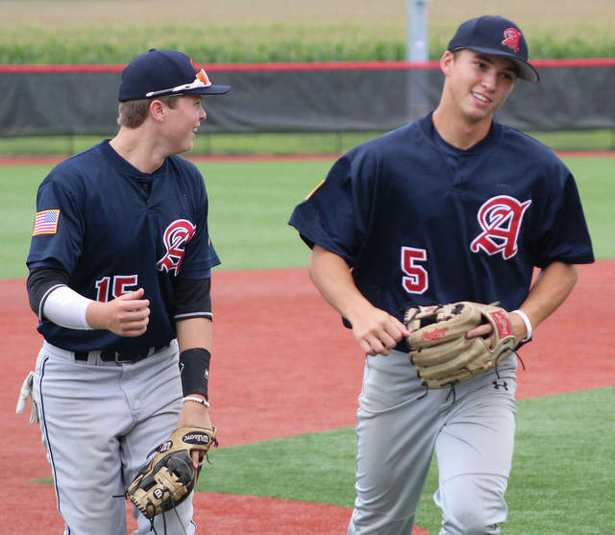 Alton Post 126 third baseman Adam Stilts (left) and shortstop Jayce Maag head toward their dugout after Maag retired a Milan hitter for the final out of an inning last July the Senior Legion state tournament at SIUE’s Simmons Baseball Complex in Edwardsville.