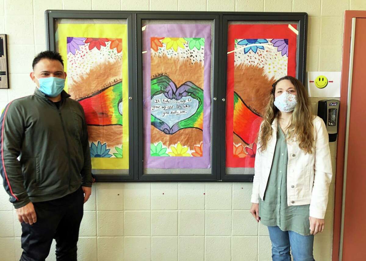 From left, state Department of Children and Families Albert J. Solnit Center employees, assistant rehabilitation therapist John Fontanez and rehabilitation art therapist Heather Cassella, show off artistic panels created by girls staying at the psychiatric facility. Creating art often helps these teens work through their issues as well as demonstrate their compassion for first responders and staff dealing with the coronavirus outbreak.