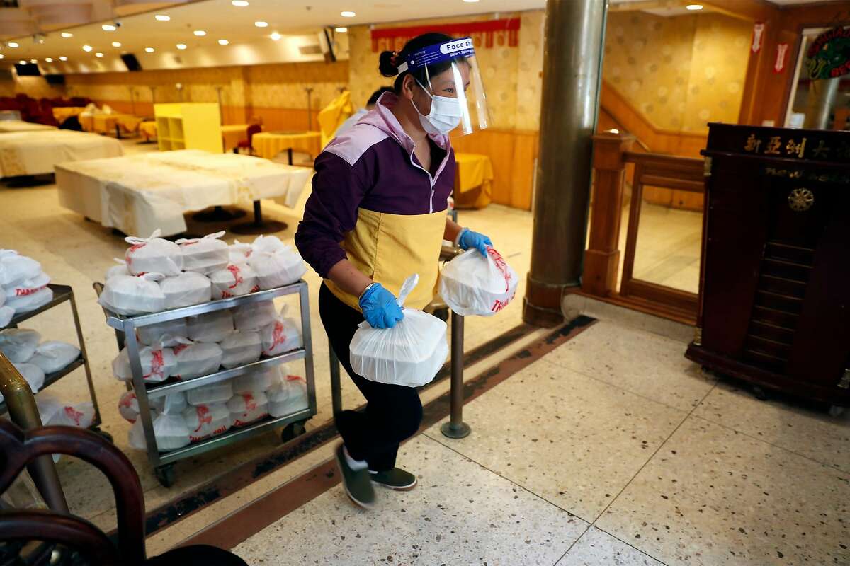 Yu Wei takes part in Chinatown Community Development Center food distribution program at New Asia Restaurant in San Francisco, Calif., on Monday, May 4, 2020.
