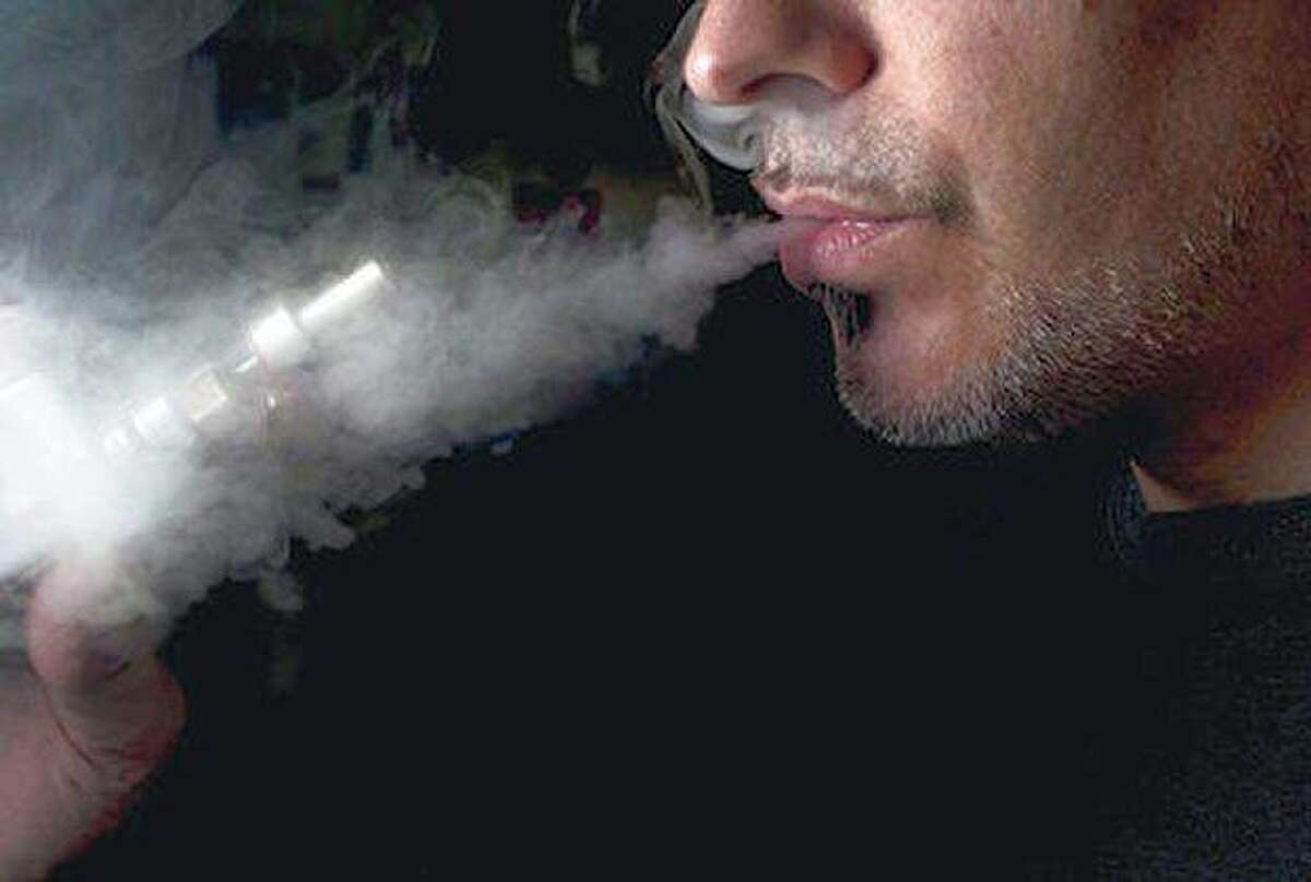 A man uses an electronic cigarette in this Associated Press file photo.