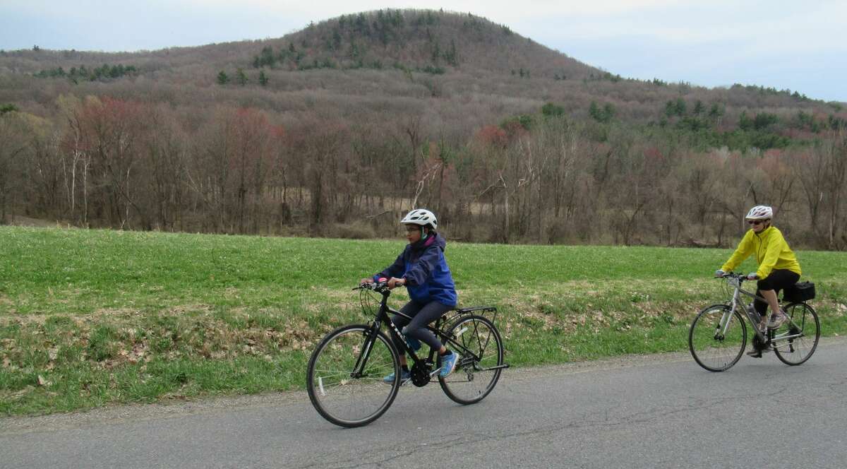 Gillian Scott, right, and her daughter ride Burton Road with Willard Mountain behind them. (Herb Terns / Times Union)