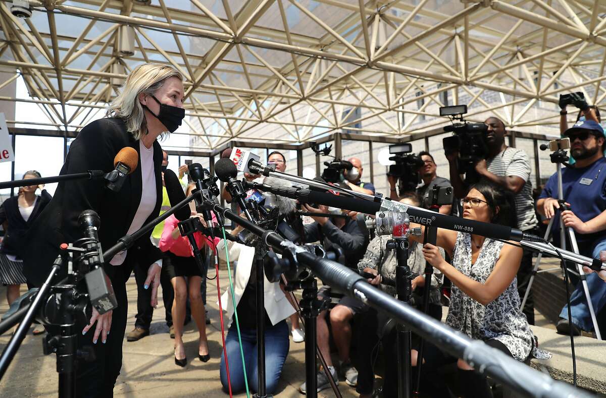 Salon owner Shelley Luther leans in to speak to the media after she was released from jail in Dallas, Thursday, May 7, 2020. Luther was jailed for refusing to keep her business closed amid concerns of the spread of COVID-19. (AP Photo/LM Otero)