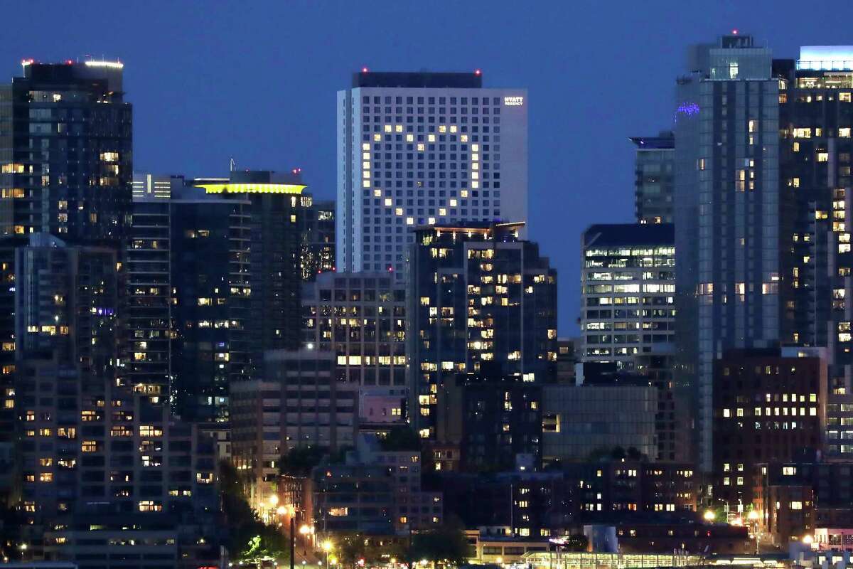 A giant heart created by windows lit by the building's engineering team is illuminated in the Hyatt Regency hotel as a way to lift the spirits of the community in the midst of the coronavirus outbreak, Thursday, May 7, 2020, in Seattle. The heart-shaped lighting began on the building in late March and has continued since.