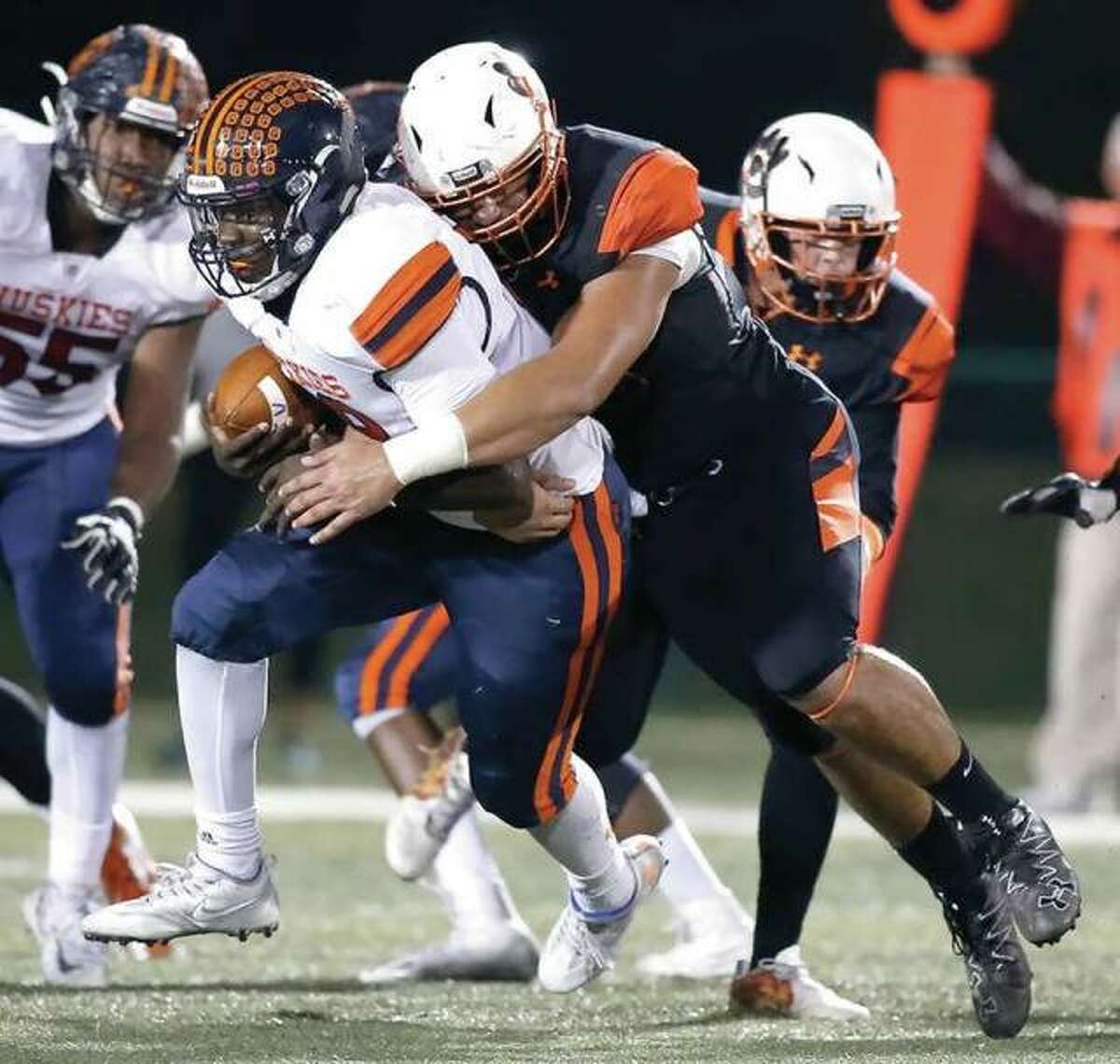 Edwardsville’s AJ Epenesa sacks Oak Park-River Forest quarterback Jeremy Hunt during the Tigers’ Class 8A first-round playoff victory in Edwardsville.