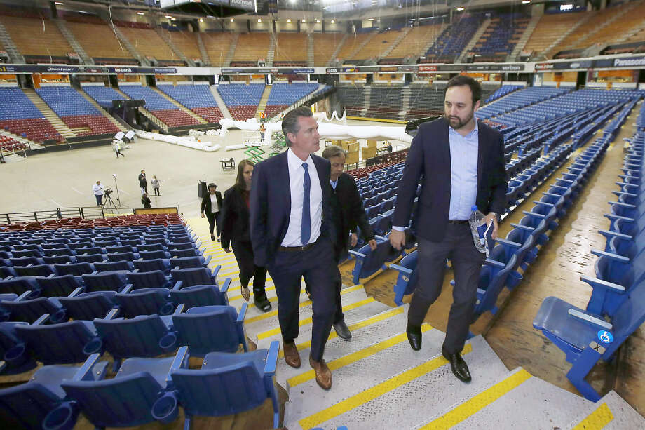 Gov. Gavin Newsom, accompanied by Jason Kenney, of the Department of General Services, tours Sleep Train Arena, the former home of the NBA's Sacramento Kings on April 6, 2020. Photo: Rich Pedroncelli / Associated Press