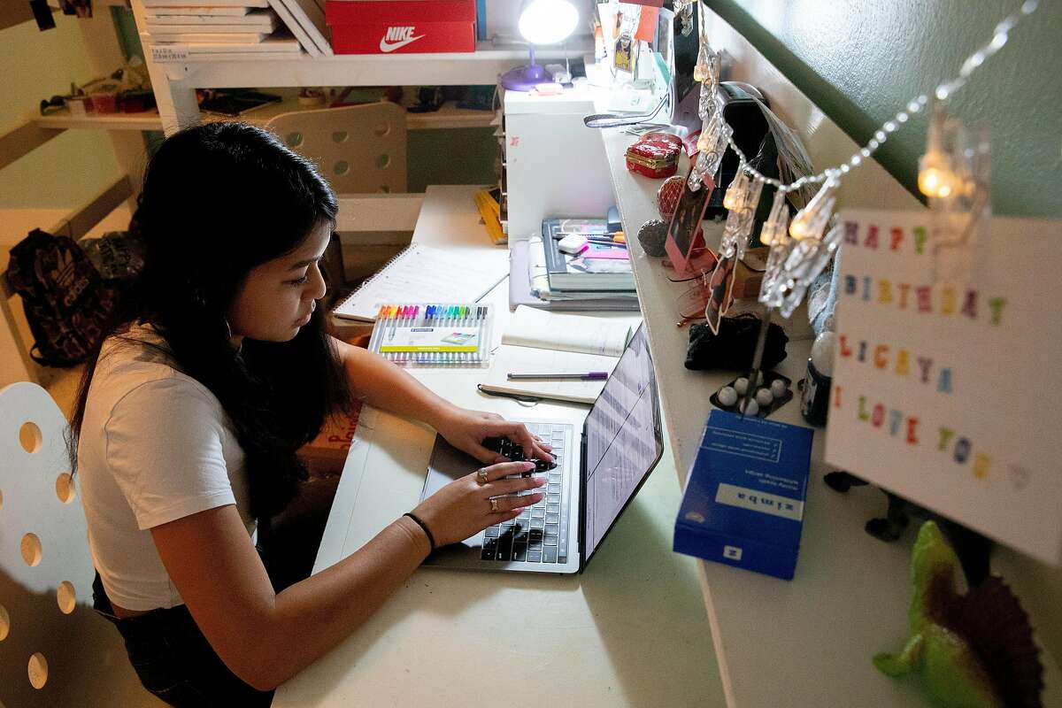 Ligaya Chinn studies for her AP Biology test in her bedroom at her home in Oakland, Calif. Thursday, May 7, 2020. For the first time, high school AP tests will be administered online only in a take-home setting due to the Coronavirus pandemic and shelter-in-place order.