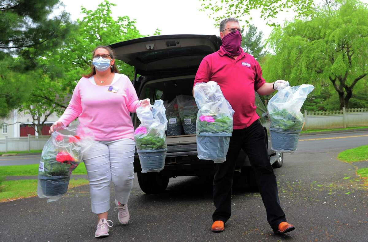 Home Instead Franchise Owners Heather and Coleman Gately deliver flower baskets for Mother's Day to a home in New Canaan, Conn., on Saturday May 8, 2020. The flowers, donated through Lowe's, were delivered to staff caregivers and the mothers and grandmothers they work with who may feel socially isolated on Mother's Day because of the coronavirus.