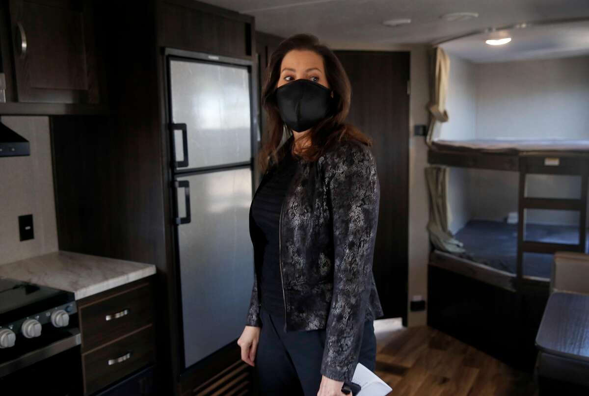 Mayor Libby Schaaf tours a trailer home parked on an empty lot near the Coliseum in Oakland, Calif. on Tuesday, May 5, 2020. Dubbed "Operation HomeBase", 67 trailers will shelter 134 homeless people who are at a significant risk if they contract the COVID-19 coronavirus