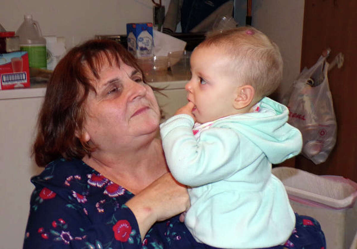 Carolyn McBride holds her granddaughter, Claramae Skidmore, who is now 3 years old. McBride, who was a registered nurse at Eden Village Retirement Center, died recently of COVID-19.