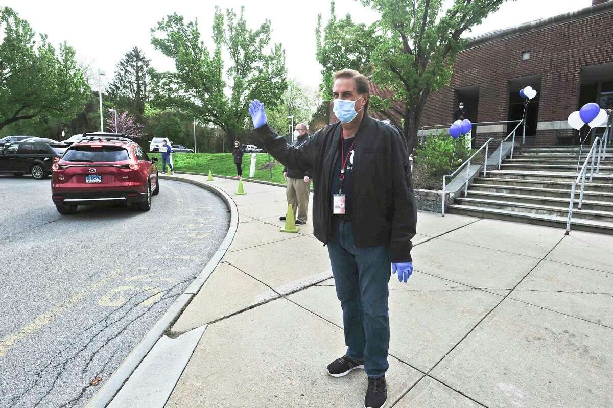 Principal Gene Schmidt waves to students during a "Smile and Wave" at Cos Cob Elementary School on May 8, 2020 in Greenwich, Connecticut. The event allowed students, who have been Distant Learning for the past nine weeks, to see their teachers in a safe and organized way, showing their appreciation since Gov. Lamont official announced that schools will remain closed. Staff members gathered in the school's back circle and each grade levels caravan through to wave and spread messages of love and happiness. The appreciation shown to the 60 plus staff, coincided with the National Teacher Appreciation Week