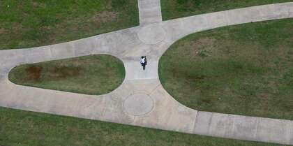 A bicyclist rides along the Brays Bayou Greenway Trail on May 6, 2020, in Houston.