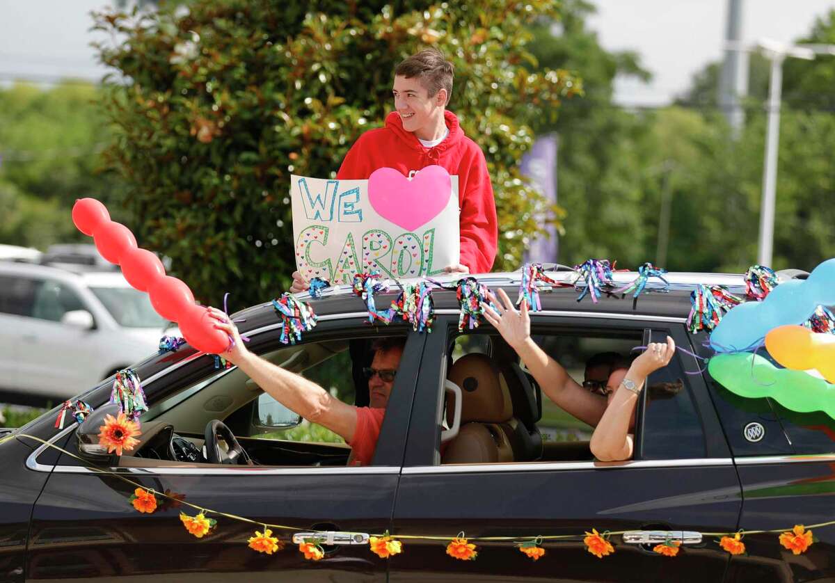 Family waves to residents during a parade at Spring Creek Village Assisted Living & Memory Care, Friday, May 8, 2020, in Spring.