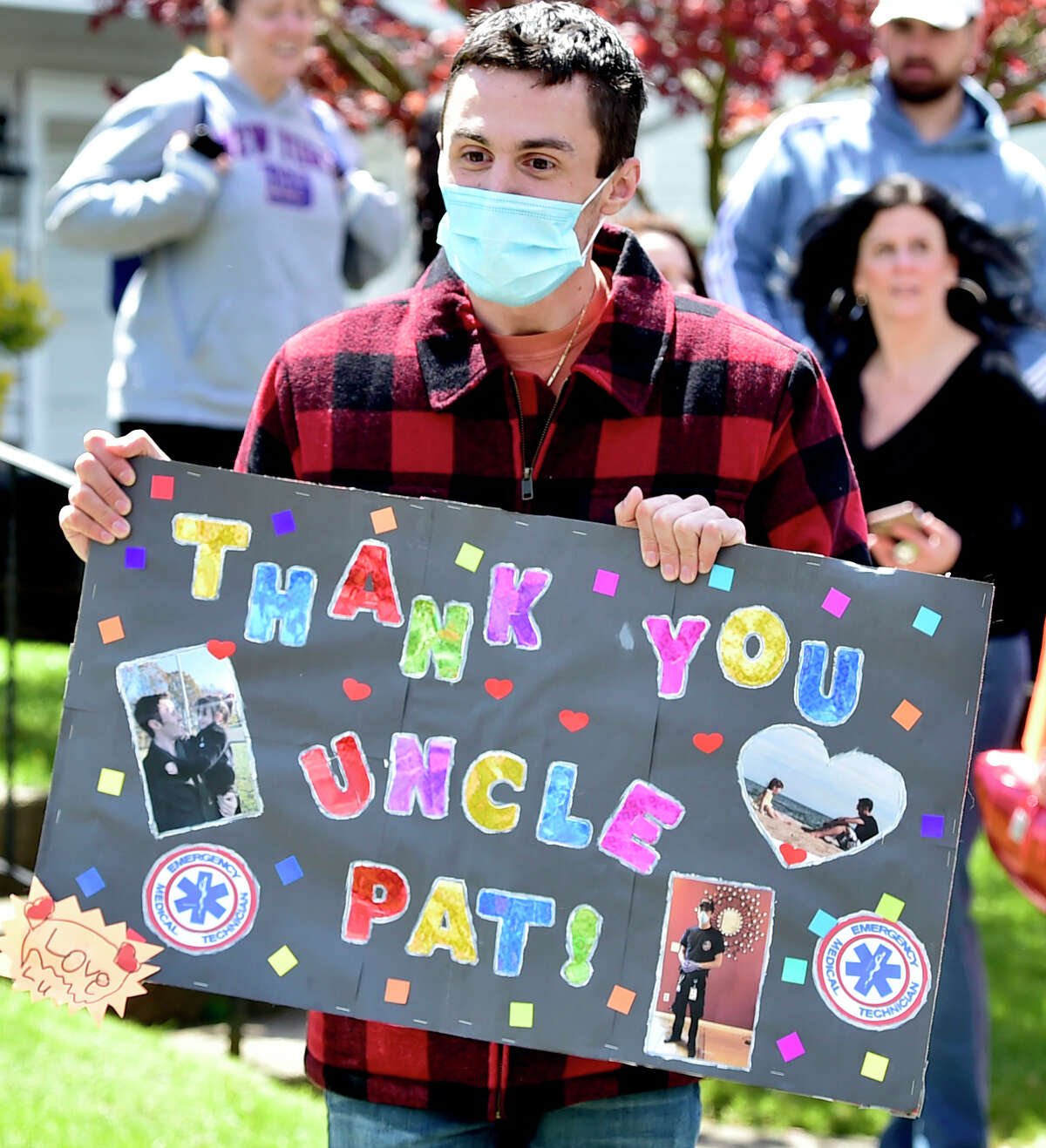 West Haven, Connecticut - Saturday, May 9, 2020: The greater West Haven area community parade their vehicles in a surprise drive-by Saturday at the West Haven home of first responder Pat D'Amato, an EMT for AMR Ambulance, thanking him for his heroism working as an EMT in the hardest hit areas of New York City during the Covid-19 / Coronavirus pandemic. D'Amato recently returned from New York. Along with local police cruisers, firetrucks, and an AMR ambulance, approximately 200 cars and trucks paraded by his home. The parade was organized by West Haven Birthday Parades organizer Kevin Ward and West Haven High School Band Director Cassandra Marcella.