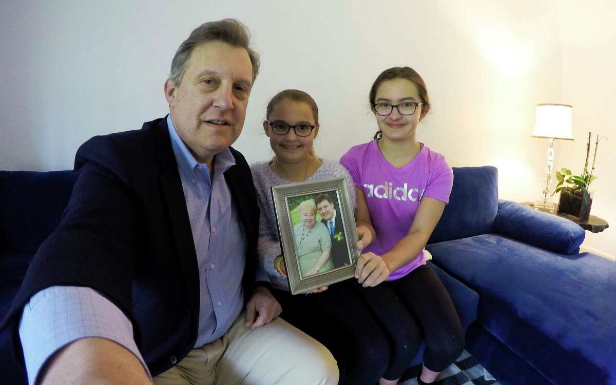 Tom Kolenberg is photographed on May 8, 2020 with his two daughters Sarah, 9 and Isabella, 13, Kolenberg in their Stamford, Connecticut home. Tom's 81-year-old mother, Mary Kolenberg, (in a photo with her son) who lives in a nursing home and has a heart condition, low kidney function and diabetes, contracted COVID-19. After three weeks in Stamford Hospital, despite her high-risk status, Mary came home.
