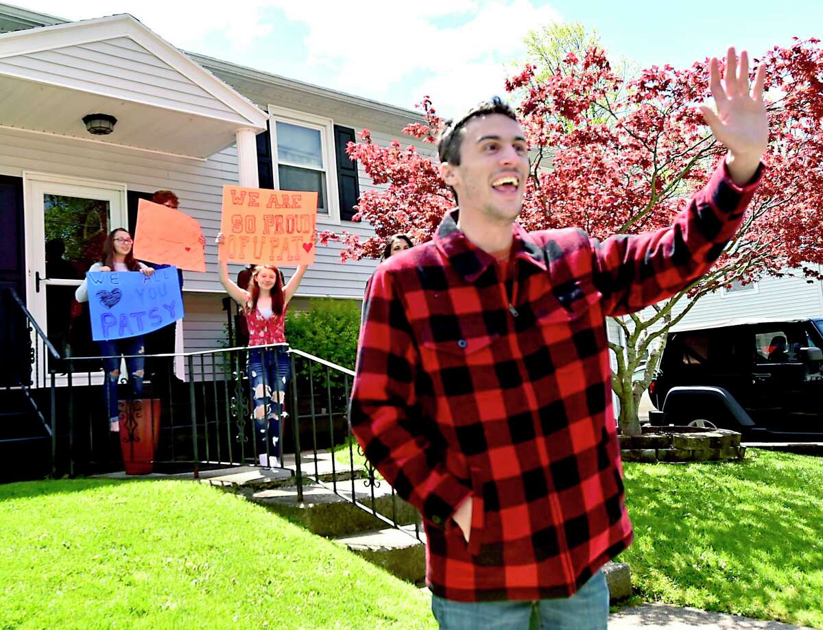 West Haven, Connecticut - Saturday, May 9, 2020: The greater West Haven area community parade their vehicles in a surprise drive-by Saturday at the West Haven home of first responder Pat D'Amato, an EMT for AMR Ambulance, thanking him for his heroism working as an EMT in the hardest hit areas of New York City during the Covid-19 / Coronavirus pandemic. D'Amato recently returned from New York. Along with local police cruisers, firetrucks, and an AMR ambulance, approximately 200 cars and trucks paraded by his home. The parade was organized by West Haven Birthday Parades organizer Kevin Ward and West Haven High School Band Director Cassandra Marcella.