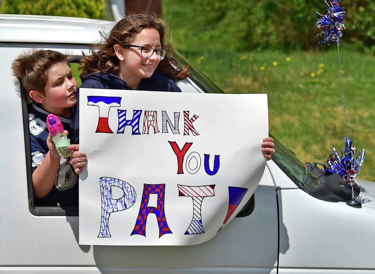 West Haven, Connecticut - Saturday, May 9, 2020: The greater West Haven area community parade their vehicles in a surprise drive-by Saturday at the West Haven home of first responder Pat D'Amato, an EMT for AMR Ambulance, thanking him for his heroism working as an EMT in the hardest hit areas of New York City during the Covid-19 / Coronavirus pandemic. D'Amato recently returned from New York. Along with local police cruisers, firetrucks, and an AMR ambulance, approximately 200 cars and trucks paraded by his home. The parade was organized by West Haven Birthday Parades organizer Kevin Ward and West Haven High School Band Director Cassandra Marcella.