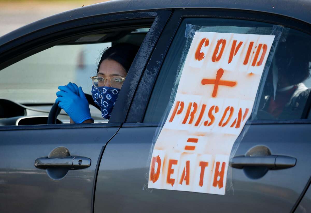 A demonstrator waits in her car before a rolling protest caravan departs for the west gate of San Quentin State Prison to demand more protection against the COVID-19 coronavirus for prisoners in Larkspur, Calif. on Saturday, May 9, 2020.