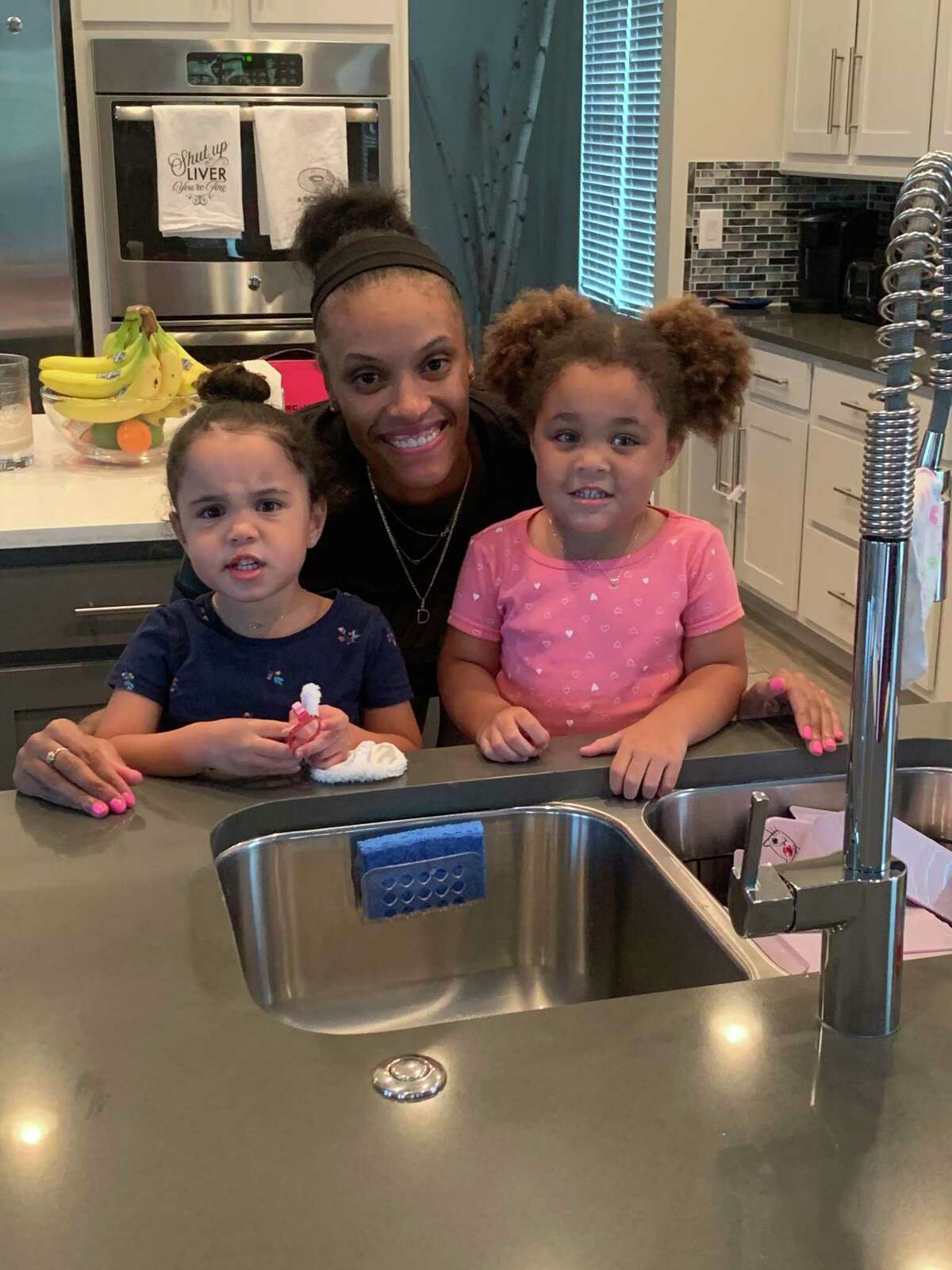 DeWanna Bonner with her daughters Cali, in the pink, and Demi, in blue.
