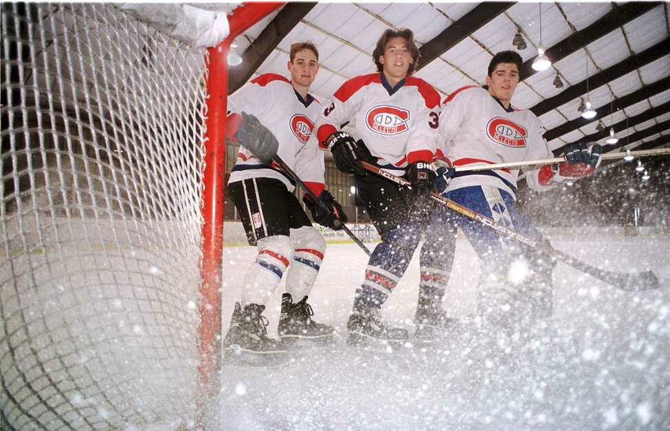 TIMES UNION PHOTO BY LUANNE M. FERRIS -- FRIDAY, MARCH 28, 1997, TROY, FREAR PARK ICE RINK, SOME OF THE DIVISION I BOUND HOCKEY PLAYERS ON THE CAPITAL DISTRICT SELECT TEAM, COACHED BY JIM SALFI, ON THE LEFT. THE THREE PLAYERS ON TOP OF THE NET ARE L-R: CURTIS VALENTINE, AGE 17 OF GANSVORT, JAY LEACH, AGE 17, OF GUILDERLAND, AND MATTHIAS TRATTNIG, AGE 17 OF AUSTRIA. THESE BOYS PLAY ON THIS JUNIOR TYPE HOCKEY TEAM AS AN ALTERNATIVE TO HIGH SCHOOL HOCKEY. THIS IS FOR A SINGELAIS STORY. 04/02/97