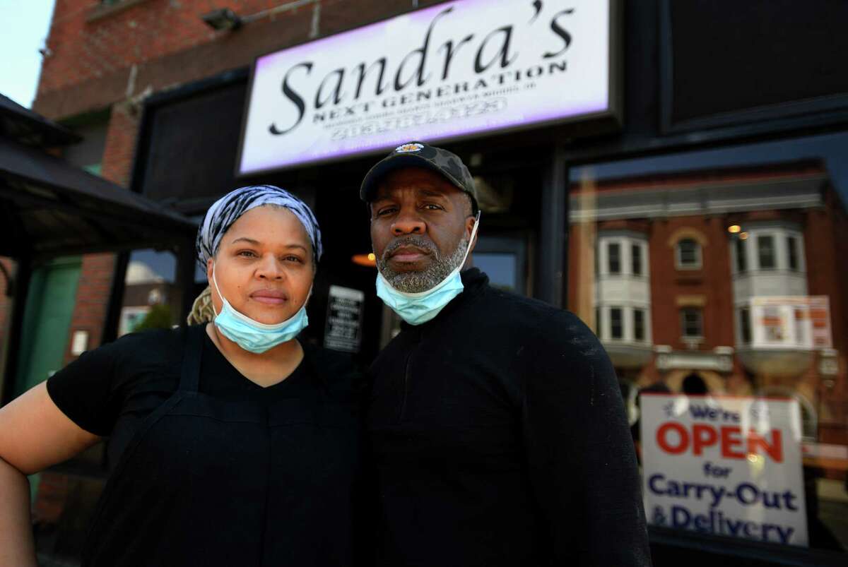 Owners Sandra and Miguel Pittman outside their popular Sandra's Next Generation restaurant in New Haven, Conn. on Sunday, May 10, 2020. They said aspects of their business, like catering, have been adversely affected by the coronavirus pandemic.