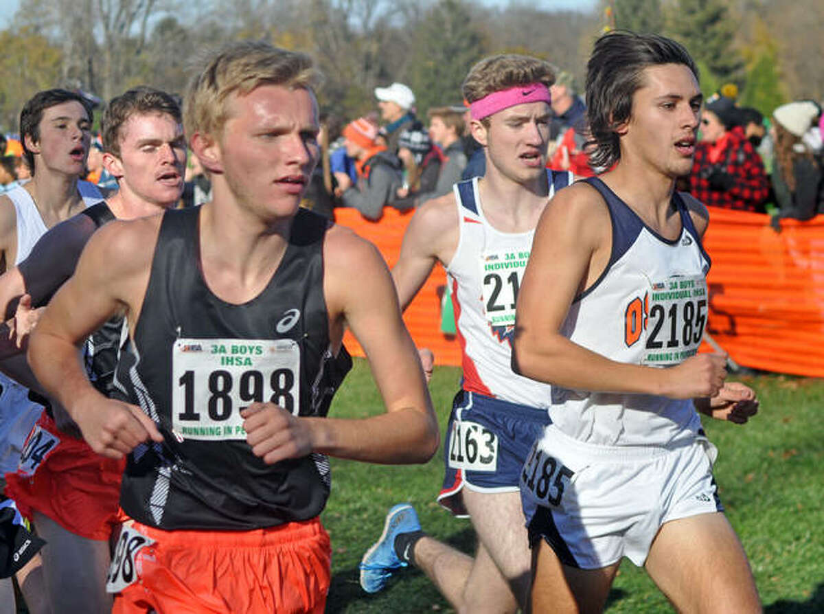 Edwardsville senior Brydon Groves-Scott, left, competes in the Class 3A state boys’ meet in East Peoria.