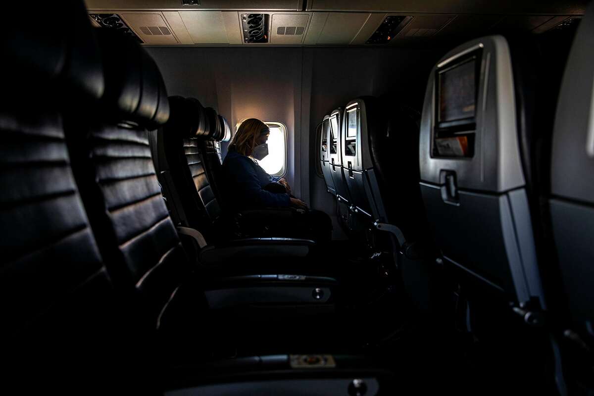 FILE -- Aboard a nearly empty United Airlines flight from Chicago to New York, April 18, 2020, amid the coronavirus pandemic. With much of the world closed for business, and no widely available vaccine in sight, it may be months, if not years, before airlines operate as many flights as they did before the crisis. (Hiroko Masuike/The New York Times)