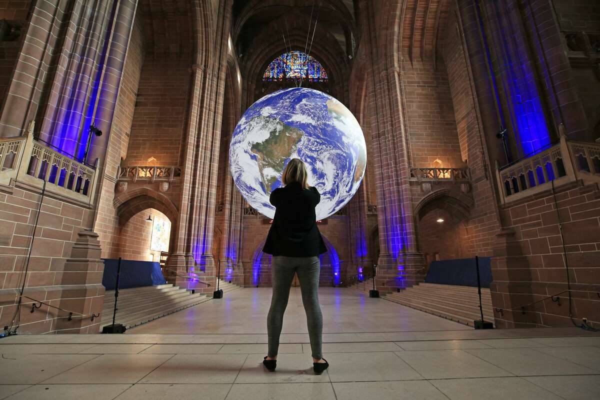 Upon viewing, the internally lit, 23-foot in diameter sphere resembling Earth aims to recreate the "Overwatch Effect." Gaia on display inside Liverpool Cathedral. (Photo by Peter Byrne/PA Images via Getty Images)