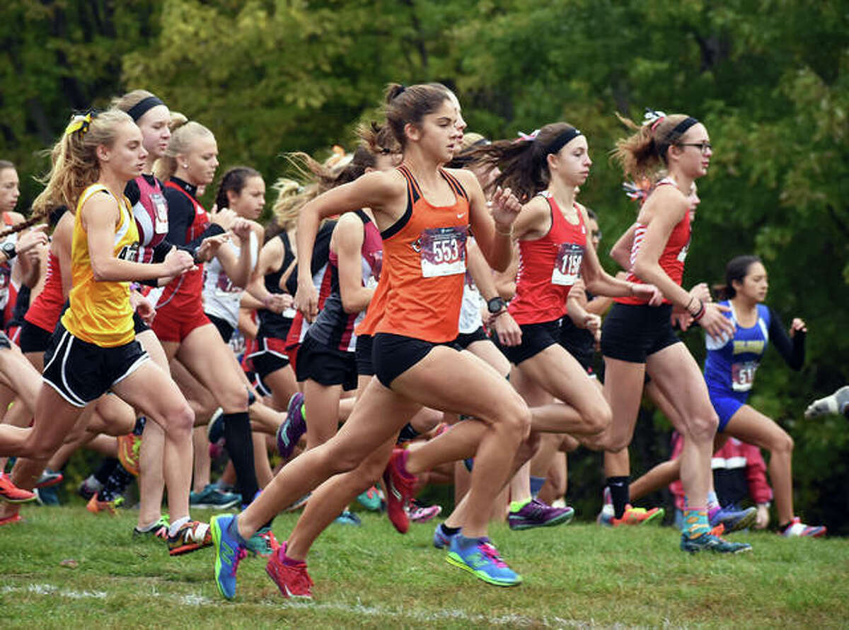 Edwardsville runner Abby Korak, front, gets off to quick start at the Class 3A Quincy Regional. Edwardsville senior Melissa Spencer runs in a race during her final season with the Tigers.