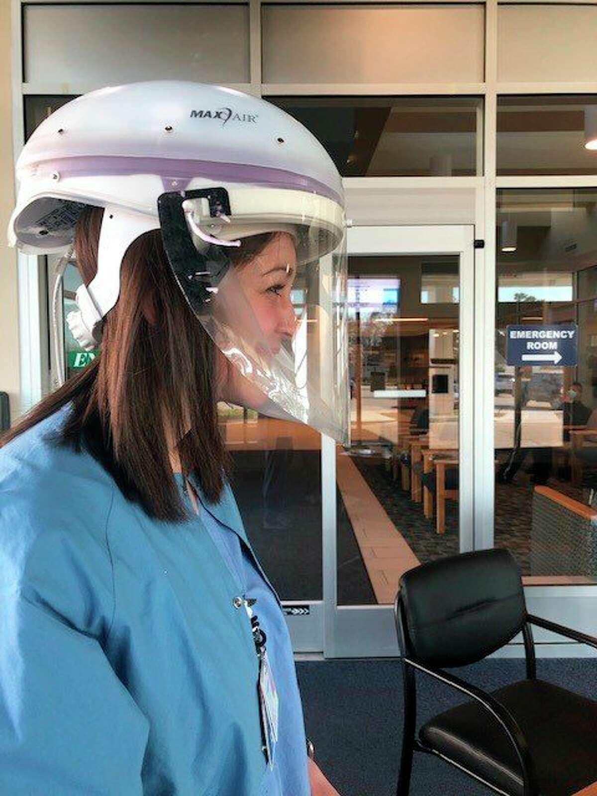 Nurse Nikki Glaza models face shields made by the Gemini Group Inc. for McLaren and Scheurer hospitals. (Gemini General Counsel Zachary Eskau/Courtesy Photo)