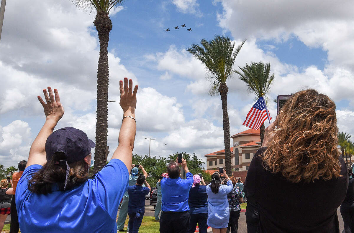 The Air National Guard's 149th Fighter Wing, consisting of four F-16s, is greeted by community members and first responders, Monday, May 11, 2020, as the planes fly over Laredo Medical Center as a tribute to frontline workers.